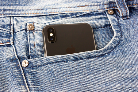 Rostov-on-Don, Russia - Feb 2018. Iphone X sticks out of the pocket of blue jeans. A new smartphone...