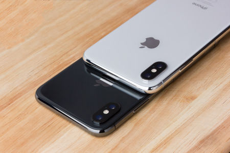 February 2018.Two Iphone X lies on a wooden table. A new smartphones from the company APPLE close-up...