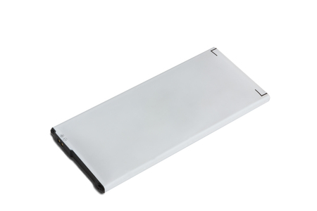 Rechargeable battery for smartphone. Inflated and faulty battery for a phone on a white background close-up.の写真素材