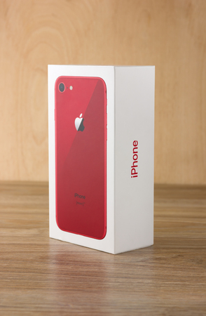 May 2018. Apple iPhone 8 (PRODUCT) RED in box on a wooden table. A new smartphone from the company APPLE close-up on a wooden surface.のeditorial素材