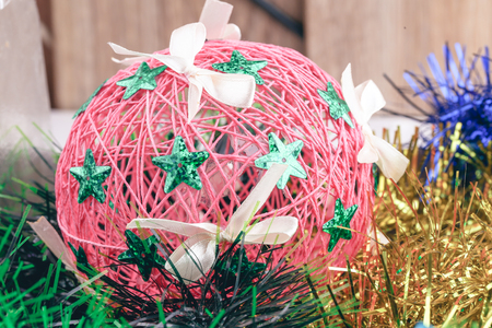 Christmas ball on a multi-colored tinsel. Handmade Christmas ball close-up.の写真素材