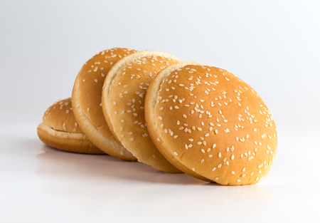 Burger buns on white background. A few buns cut in half close up on a white background.の写真素材