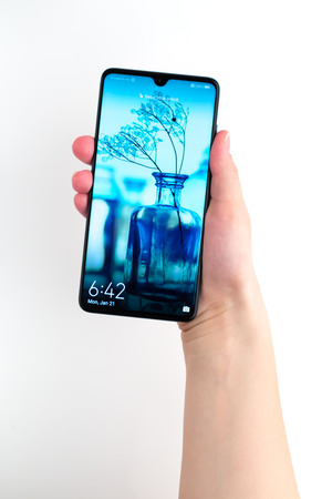 Rostov-on-Don, Russia - January 2019. Huawei Mate 20 Midnight Blue. A new smartphone from the company Huawei in hand on a white background.のeditorial素材