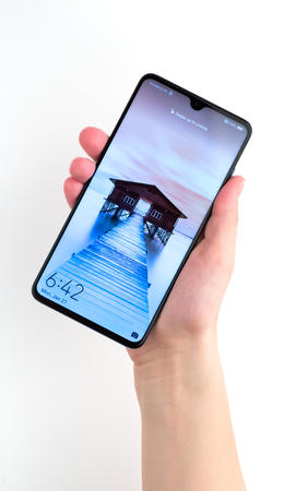Rostov-on-Don, Russia - January 2019. Huawei Mate 20 Midnight Blue. A new smartphone from the company Huawei in hand on a white background.のeditorial素材