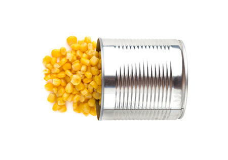 Canned corn on a white background. Corn closeup in an iron jar on a white background.の写真素材