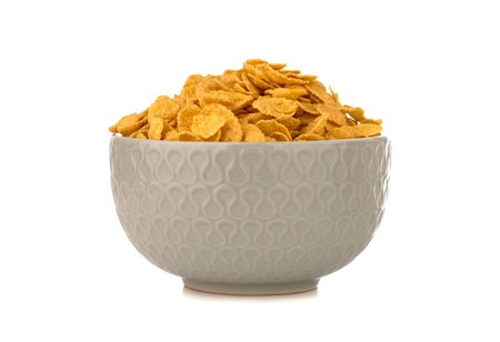 Cornflakes on a white background. Cornflakes in a bowl close-up.の写真素材