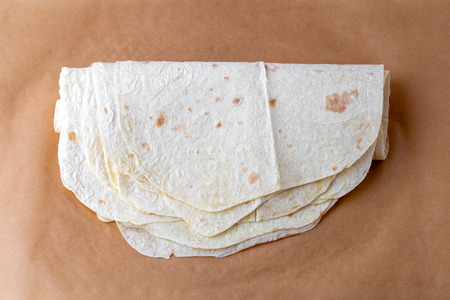 Thin pita bread on baking paper. Armenian pita bread close-up.の写真素材