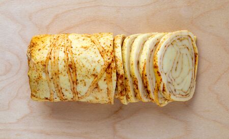 Cheese on a wooden board. Cheese with spices close-up. Top view.の写真素材