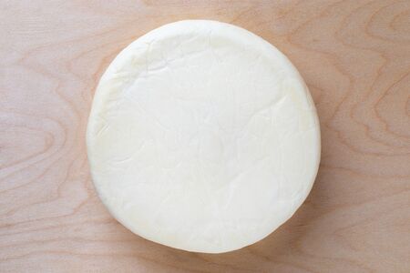 Cheese on a wooden board. Cheese close-up. Top view.