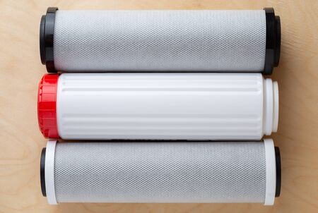 Water filters on a wooden background. New filters for water purification close-up.の写真素材