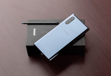 Rostov-on-Don, Russia - December 2019. Samsung Galaxy Note 10 on a wooden table. Smartphone on box...