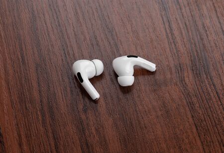 Rostov-on-Don, Russia - December 2019. Apple AirPods Pro on a wooden table. Wireless headphones...