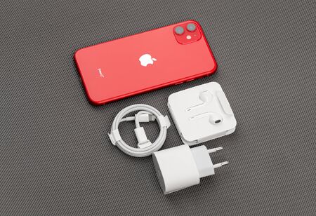 Rostov-on-Don, Russia - November 2019. Apple iPhone 11 PRODUCT RED and kit on a gray surface. New smartphone from the company Apple close-up.のeditorial素材