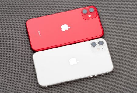 Rostov-on-Don, Russia - November 2019. Apple iPhone 11 PRODUCT RED, Apple iPhone 11 White on a gray surface. New smartphones from the company Apple close-up.のeditorial素材