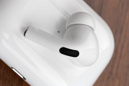Rostov-on-Don, Russia - December 2019. Apple AirPods Pro on a wooden table. Wireless headphones and...