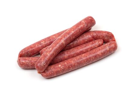 Raw sausages on a white background. Grilled sausages close-up on a white background.の写真素材