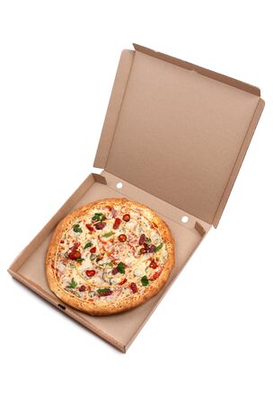 Hot Pizza in an open cardboard box. Tasty pizza with cheese, sausage, jalapenos and tomatoes on a white background.の写真素材