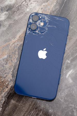 Rostov-on-Don, Russia - February 2021. IPhone 12 on marble surface. Close-up of a smartphone with a broken case.のeditorial素材