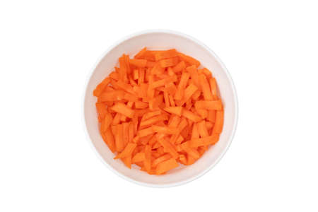 Sliced carrots in a plate on a white background. Fresh carrots cut pieces close-up.の写真素材