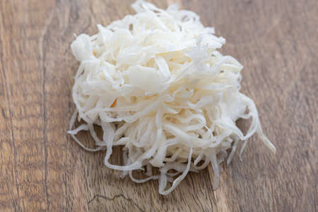 Sauerkraut on the table. Pickled cabbage close-up on a wooden table.