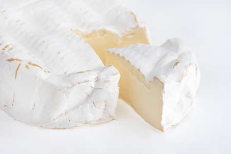 Camembert on a white background. Camembert cheese close-up on a white background.