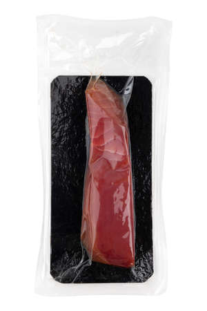 Vacuum packed tuna on a white background. A piece of fresh tuna in the package close-up on a white...