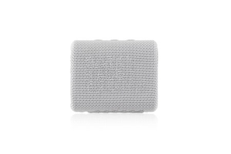 Wireless speaker on a white background. Round music speaker close-up.の写真素材