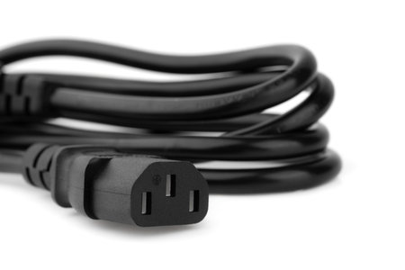 Plug connection from the power supply of a personal computer on a white background. Wire with a plug...