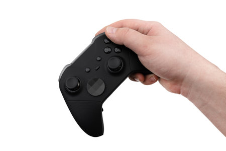 Joystick in hand on a white background. Gamepad in hand closeup isolated on white background.
