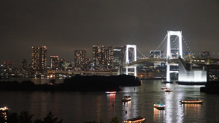 Rainbow Bridge in Tokyo at night, Japan. The bridge crosses the Odaiba River.の写真素材