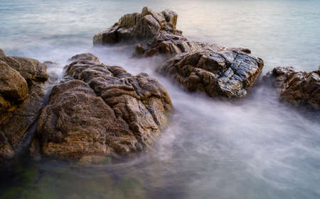 rounded rocks in the middle of the sea with mist and silk effect, blanes catalonia spainの写真素材