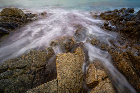 trace of sea water between rocks with sharp edges and silk effect, Blanes, Catalonia, Spainの写真素材