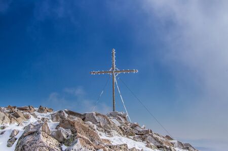 Cross on a mountain peakの写真素材