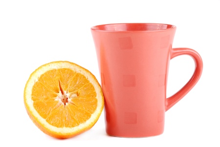 Colour cup and the fresh cut orange near to it.の写真素材