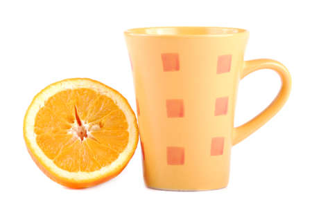 Colour cup and the fresh cut orange near to it.の写真素材