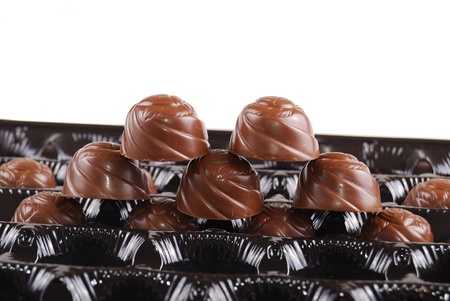 Chocolates in a box of black colour. A dessert.