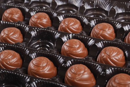 Chocolates in a box of black colour. A dessert.の写真素材