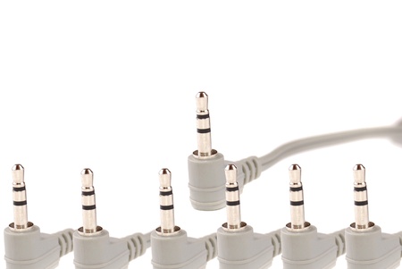 Small easy ear-phones of silvery colour with a cable and the plug.