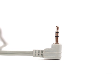Small easy ear-phones of silvery colour with a cable and the plug.の写真素材