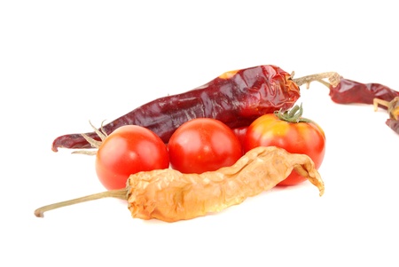 Bitter pepper of red colour and tomatoes on a white backgroundの写真素材