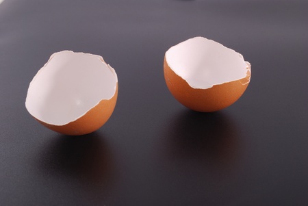 Broken egg shell isolated on black backgroundの写真素材