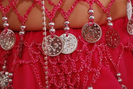 The young girl in an Oriental dress with metal ornamentsの写真素材