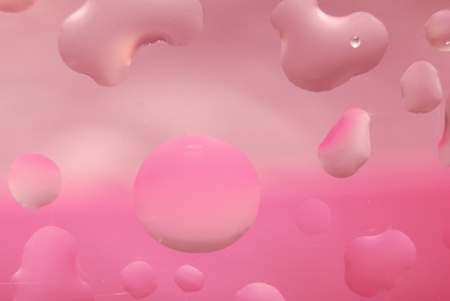 Multi coloured drops from water on glassの写真素材