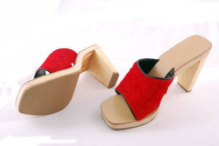 Red female shoes with a buckle on a white background