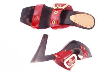 Red female shoes with a buckle on a white background