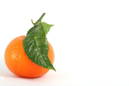 Tangerine with green leaves and water drops isolated on whiteの写真素材