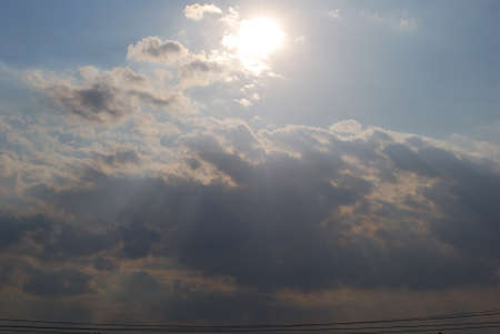 The sunset sky with multi-coloured clouds beams of the sun and lightの写真素材