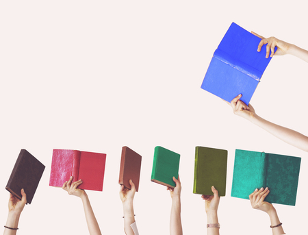 Hands holding different books on isolated backgroundの写真素材