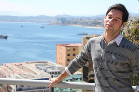 boy feeling music at coastの写真素材