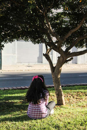 Girl meditating in front of a treeの写真素材